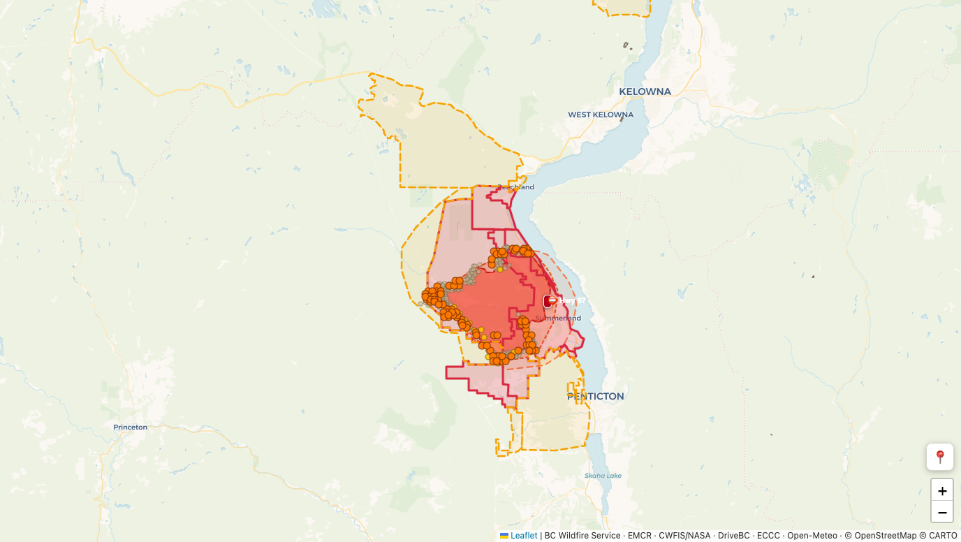 Live ClearWatch monitoring view of the Bald Range fire near Summerland BC: red evacuation order zones, orange alert zones, satellite heat detections around the fire perimeter, and a Highway 97 closure marker